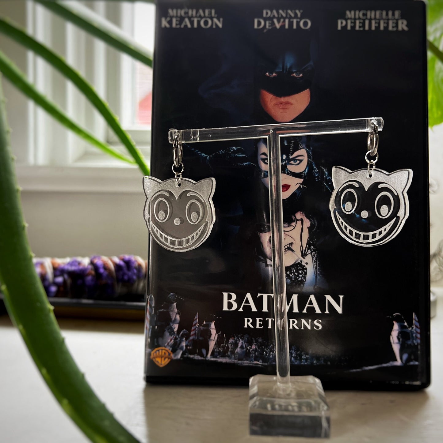 Shreck Cat-inspired earrings and keychains from Batman Returns.