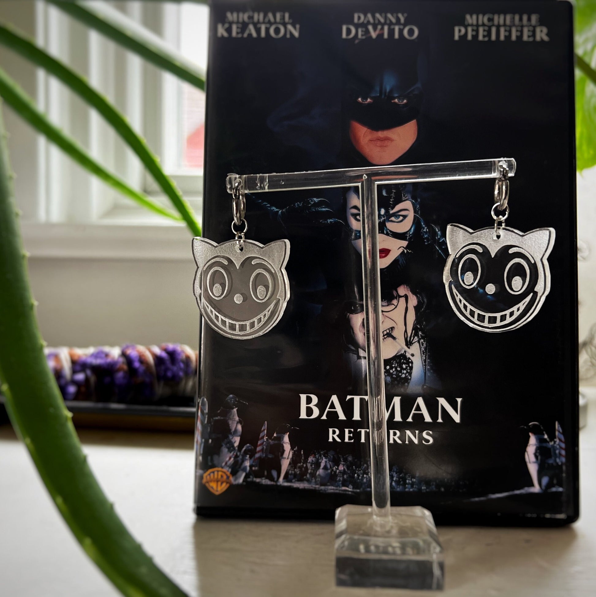 Shreck Cat-inspired earrings and keychains from Batman Returns.
