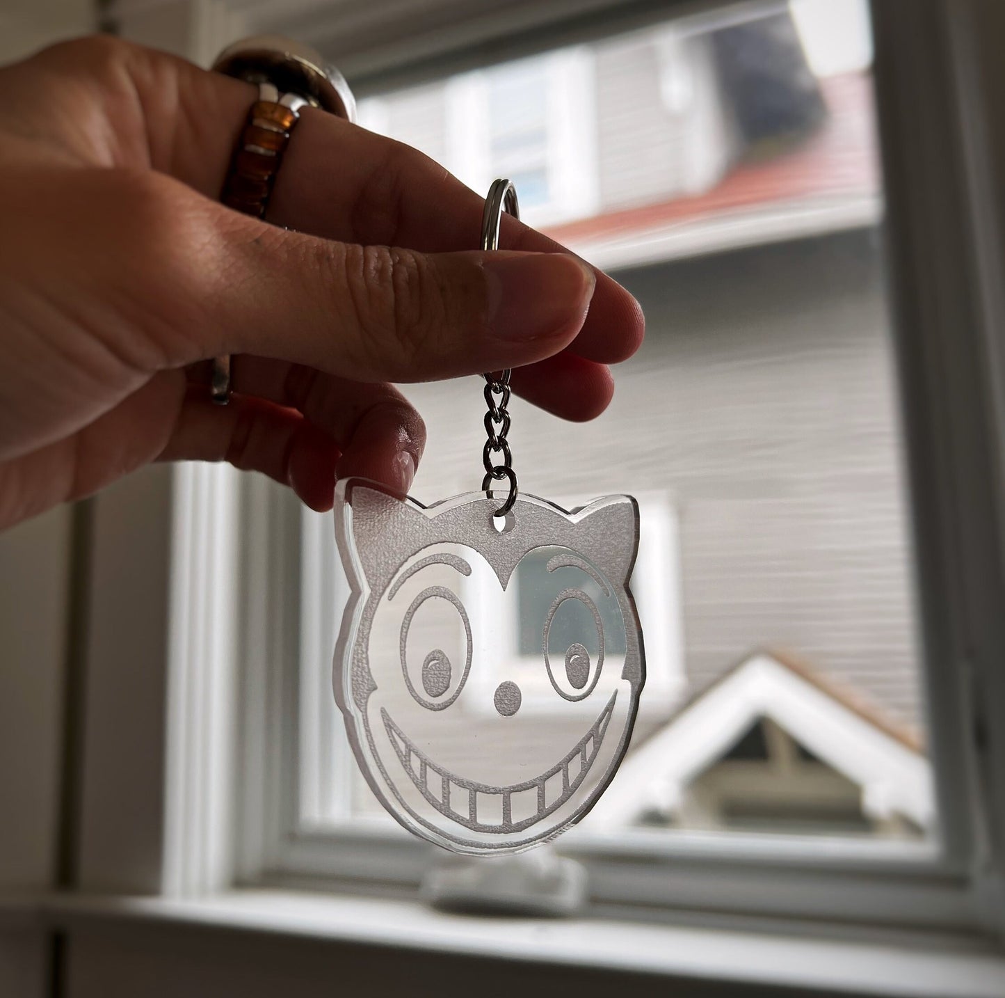 Shreck Cat-inspired earrings and keychains from Batman Returns.