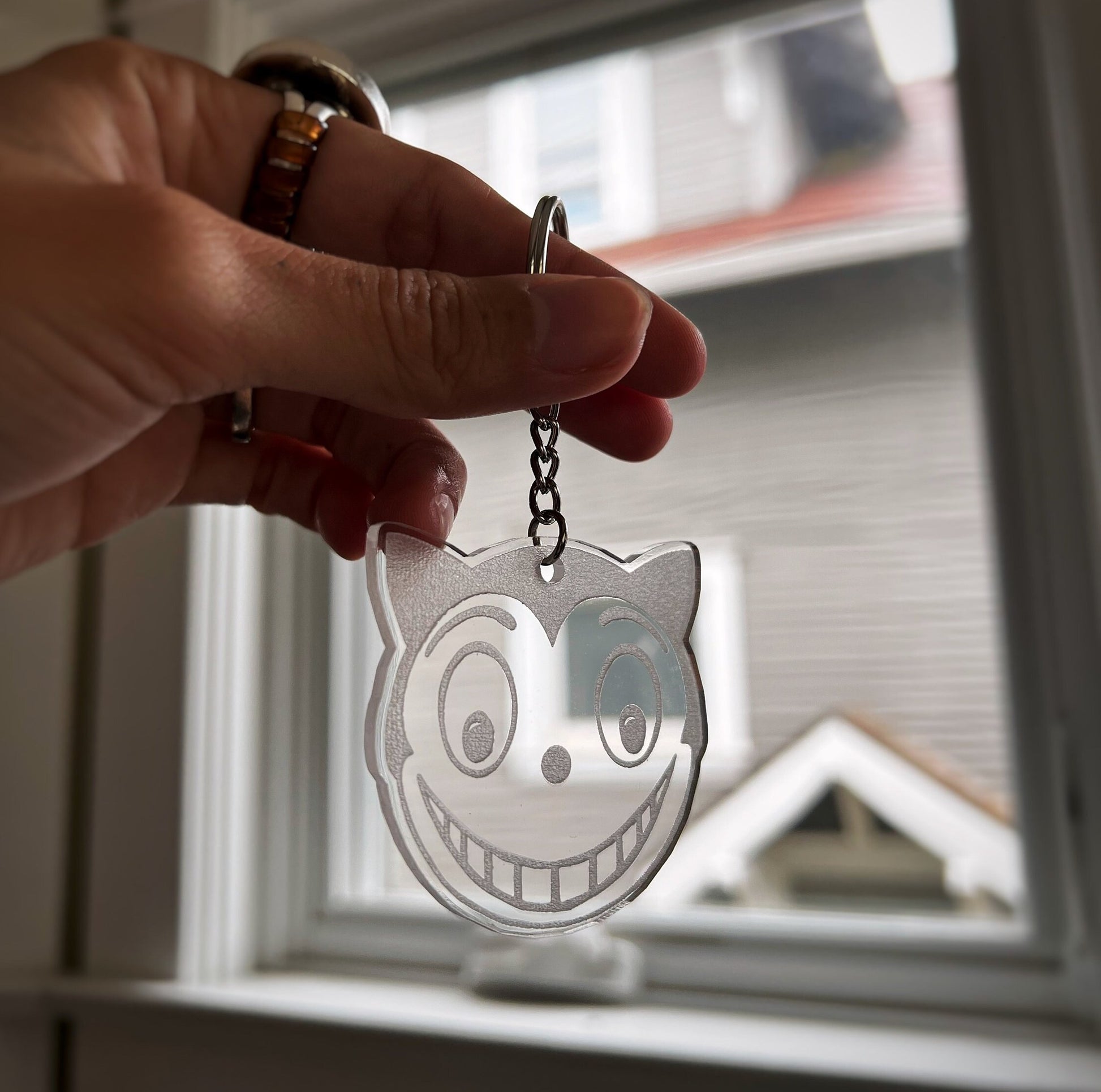 Shreck Cat-inspired earrings and keychains from Batman Returns.