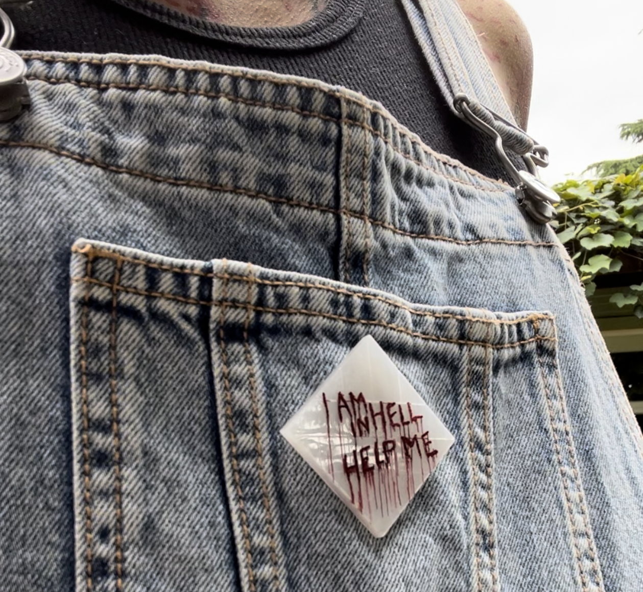 Hellraiser-inspired 'Help Me, I Am in Hell' pin or earring set – perfect horror accessories for fans of Clive Barker's classic.
