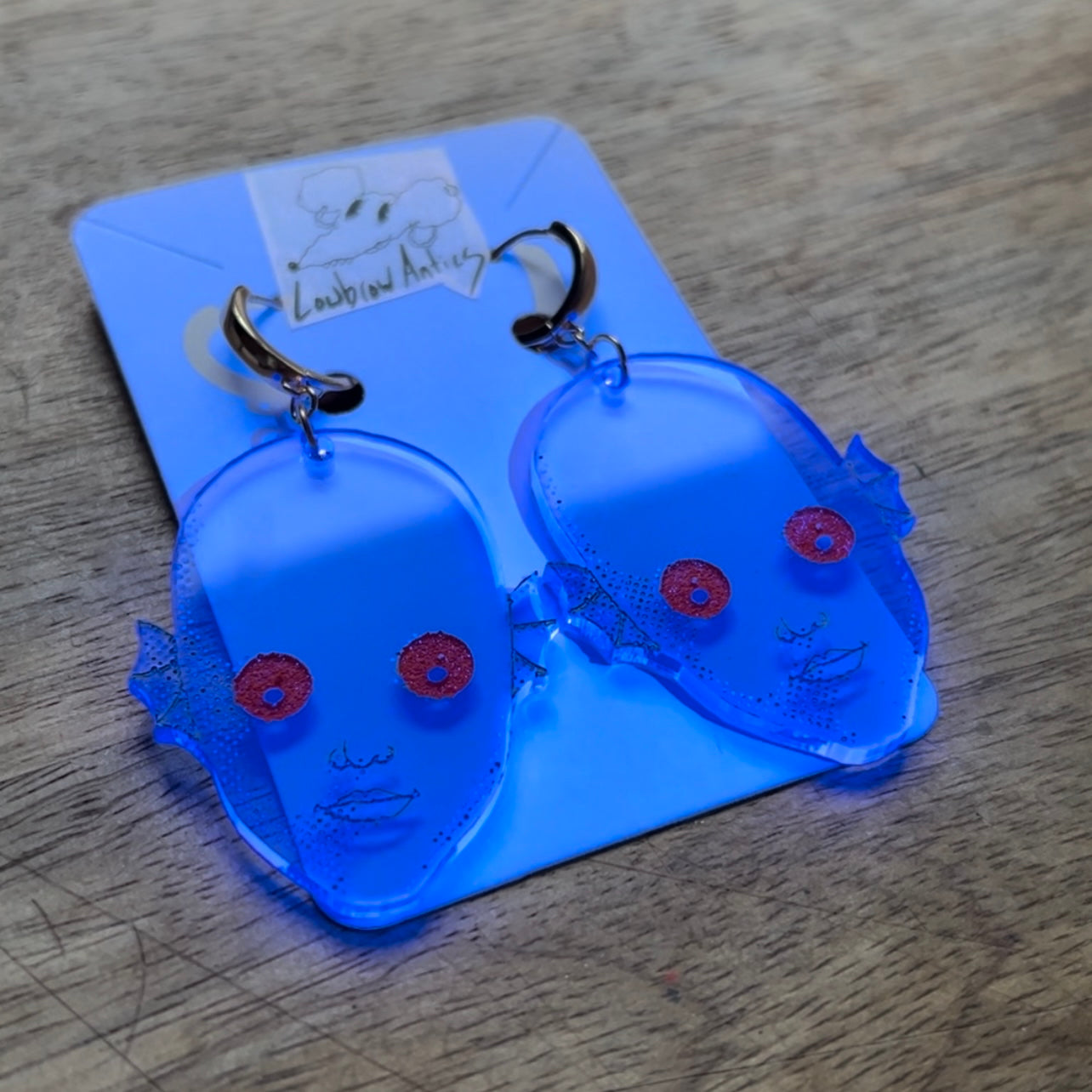 Handmade blacklight earrings inspired by the cult classic Fantastic Planet.