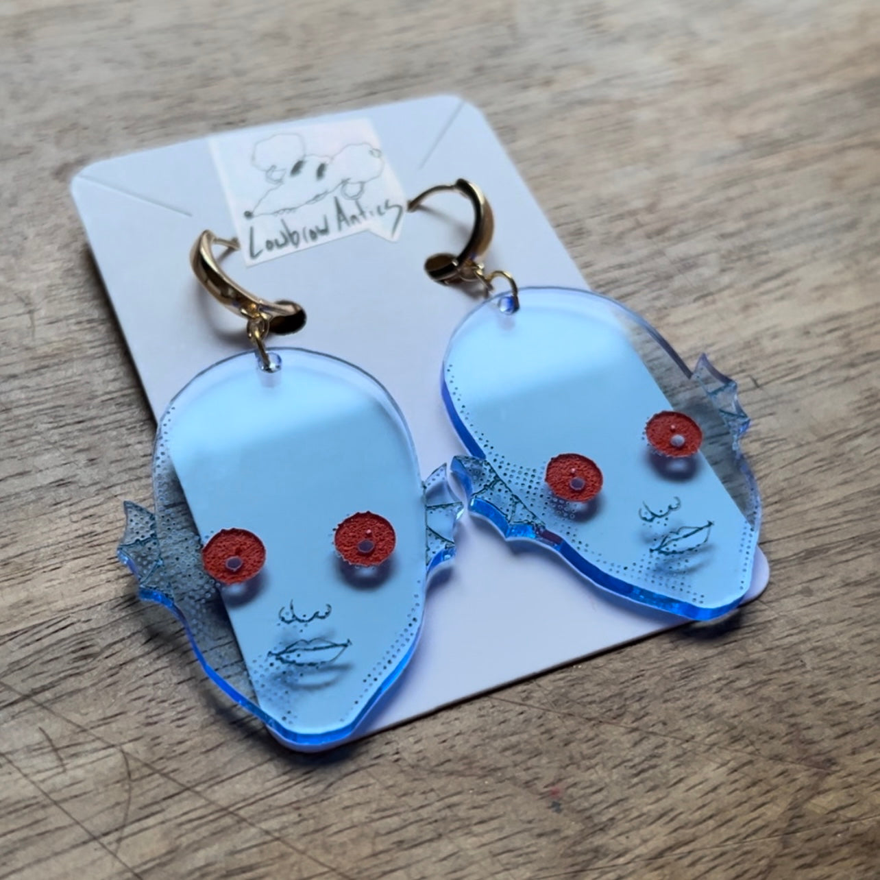 Handmade blacklight earrings inspired by the cult classic Fantastic Planet.