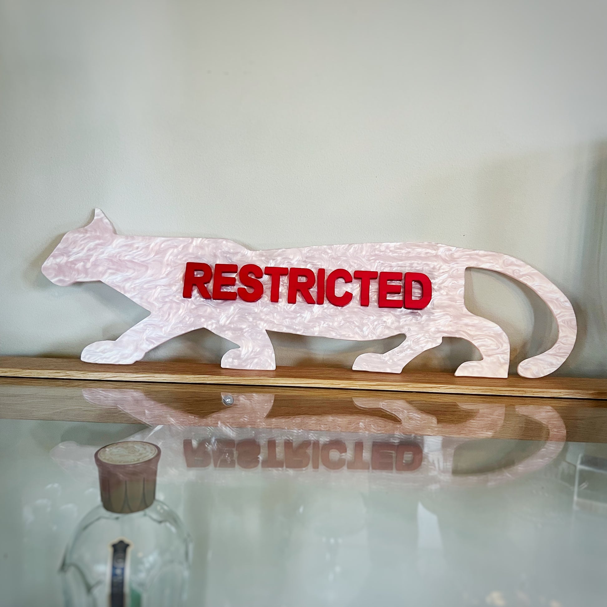 Example of a finished Restricted Panther Wall Art Piece by Lowbrow Antics, in Pink and Red Pearl Colorway.